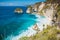 Tropical Diamond beach with coconut palms and cliff in Nusa Penida, Bali, Indonesia