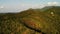 Tropical forest on island. Fantastic drone view of green jungle on mountain ridge of amazing tropical island. Blue sea