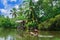 Tropical forest on the river bank .Fisherman floating in a boat.