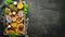 Tropical fruits on a brown background: papaya, mangosteen, cactus fruit, pytahaya, pineapple. Top view.