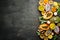 Tropical fruits on a brown background: papaya, mangosteen, cactus fruit, pytahaya, pineapple. Top view.