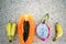 Tropical fruits lie on the sand background