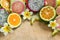 Tropical fruits tangerine, guava, dragon fruit, star fruit, sapodilla with flowers of plumeria on the wooden background.