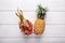 Tropical fruits on white. Dragon fruit and pineapple on white wooden background. Healthy food. Summer concept. Top view, copy