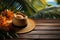 Tropical getaway concept, large hat on a wooden tabletop