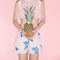 Tropical girl holding pineapple.