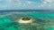 Tropical Guyam Island with a sandy beach and tourists.