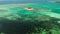 Tropical Guyam Island with a sandy beach and tourists.