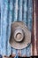 Tropical hat hanging on a rust zinc wall in a hut farm in Asia