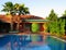 tropical house with palms and swimming pool