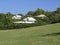 Tropical houses in Caribbean garden. Intense blue sky