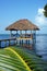 Tropical hut over water with thatched roof