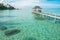 Tropical hut and wooden bridge at holiday resort. Summer travel