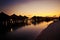 Tropical huts along a beach at sunset