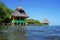 Tropical huts with thatched roof over the sea