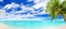 Tropical island beach panorama, turquoise sea lagoon, blue water ocean bay panoramic view, green palm tree leaves, white sand, sun