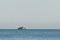 Tropical island on open sea with light tower Ionian Sea, Greece