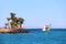 Tropical island with palm trees and promenade ship on sea. Vacations concept