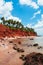 Tropical island red cliff  rock beach with blue sky and clouds in summer, tranquil serene ocean scenery. Fang Daeng in Prachuap