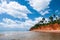 Tropical island red cliff  rock beach with blue sky and clouds in summer, tranquil serene ocean scenery. Fang Daeng in Prachuap