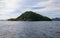 Tropical island in still sea. Palawan island seascape. Philippines travel photo. Beautiful green island with sandy beach