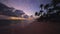 Tropical island sunrise. Sandy beach, palm trees and caribbean sea.