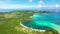 A tropical island with a turquoise lagoon and a sandbank. Caramoan Islands, Philippines.