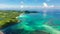 A tropical island with a turquoise lagoon and a sandbank. Caramoan Islands, Philippines.