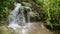 Tropical jungle waterfall with strong stream, Java, Indonesia