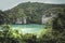 Tropical lagoon bay landscape limestone rocks and palm trees with lush foliage and turquoise sea