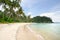 Tropical landscape with deserted amber sand beach, coconut palm trees and turquoise tropical sea on Koh Chang island in Thailand