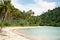 Tropical landscape with deserted amber sand beach, coconut palm trees and turquoise tropical sea on Koh Chang island in Thailand