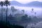 Tropical landscape, morning mist over the village on the lake, mountain view