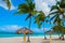 Tropical landscape Playa Esmeralda, Holguin, Cuba. Caribbean sea. Beautiful Paradise beach: umbrellas, sea, palm trees, sand.