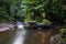 Tropical landscape. River and balinese temple in rainforest. Hindu religion. Soft focus. Slow shutter speed, motion photography.