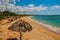 Tropical landscape with yellow sand, blue Caribbean sea, coconut palms and umbrellas. Cienfuegos, Cuba, Rancho Luna Beach.