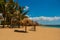 Tropical landscape with yellow sand, blue Caribbean sea, coconut palms and umbrellas. Cienfuegos, Cuba, Rancho Luna Beach.