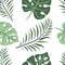 Tropical leaves of monstera, royal fern green color seamless pattern on a white background. Design suitable for textile