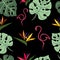 Tropical leaves of monstera, royal strelitzia flower and flamingo seamless pattern on a black background