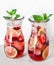 Tropical lime, strawberry and mint refreshing summer lemonade on a light background