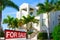 Tropical luxury mansion house w SOLD sign and palm trees
