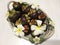 Tropical mangosteen fruits in ceramic basket, decorated with frangipani flowers