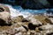 Tropical mountain stream with sunbeam in a morning.Amazing view of natural waterfall with crystal clear water among