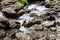 Tropical mountain stream with sunbeam in a morning.Amazing view of natural waterfall with crystal clear water among