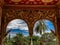 A tropical oasis viewed through a temples arched windows.