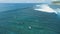 Tropical ocean with surfing waves and surfers. Aerial view