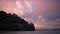 Tropical ocean view with close-up island in pink sunset twilight sky