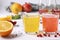 Tropical orange and pomegranate juice with basil seeds or falooda seeds or tukmaria in glasses and bottles on white background,