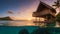 Tropical overwater bungalow at sunset