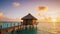 Tropical overwater bungalow at sunset